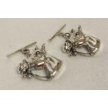 A pair of silver cufflinks in the shape of horses heads, marked sterling to reverse.