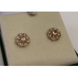 A pair of 9ct rose gold stud earrings set with morganite and seed pearls by Luke Stockley, London.