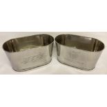 A pair of Bollinger Champagne buckets with engraved details to sides.