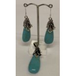 A teardrop shaped turquoise pendant with decorative 925 silver mount and bale and matching earrings.