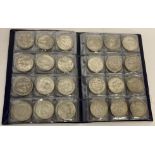 A folder containing 72 assorted white metal coins from around the world.