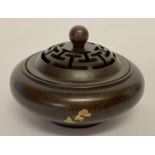 A Chinese bronze lidded censer with gold splash detail.