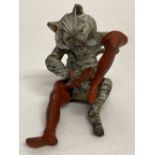 After Bergmann - a cold painted bronze figure of a cat, cleaning his red boots.