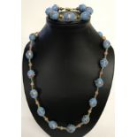A matching necklace and bracelet set made with pale blue Venetian style glass beads.