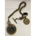 A vintage brass cased pocket watch and chunky albert style chain with pendant and T bar.