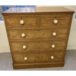 An Edwardian satin wood 5 drawer chest of drawers with ceramic bun handles and brass locks.
