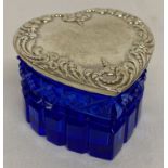 A heart shaped blue cut glass trinket box with embossed decoration to lid.