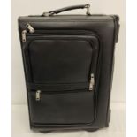 A wheeled faux leather pilot's case with combination locks.