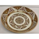 A large Dutch ceramic charger with floral decoration and lustre detail. Etched initials to side.