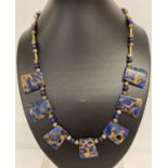 A boxed lapis Lazuli and gold tone bead Cleopatra style necklace with T bar clasp.