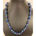 A 20" Lapis Lazuli and turquoise beaded necklace with white metal S shaped clasp.