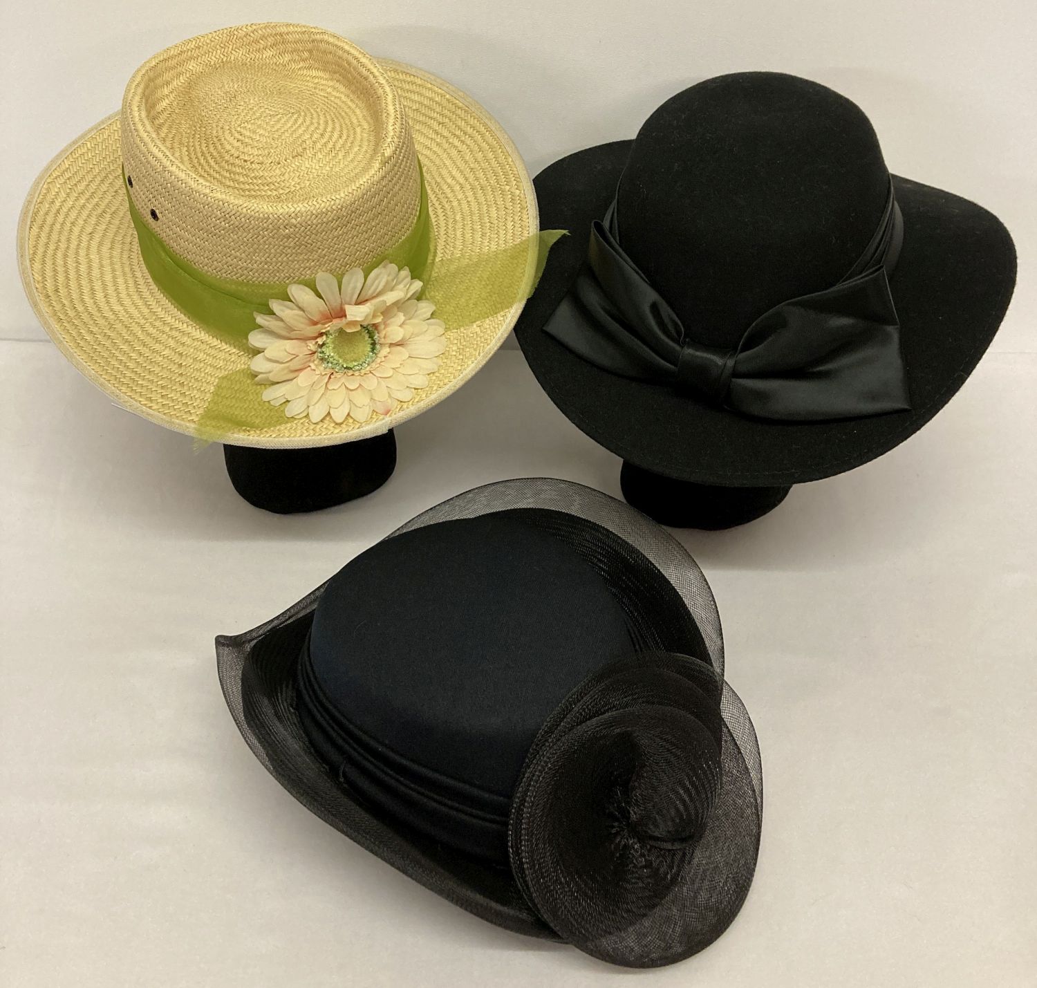 3 ladies hats. A summer straw hat with green chiffon ribbon and flower detail.