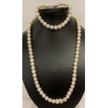 A 23" string of large freshwater pearls with gold tone S shaped clasp and matching bracelet.