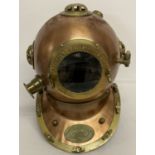 A copper and brass Anchor Engineering divers helmet with glass panels.