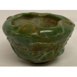 A carved green jade Chinese bowl with cherry blossom and bird decoration to outer bowl.