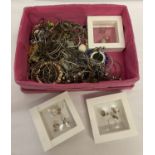 A basket of mostly silver and gold tone costume jewellery to include necklaces and gift sets.