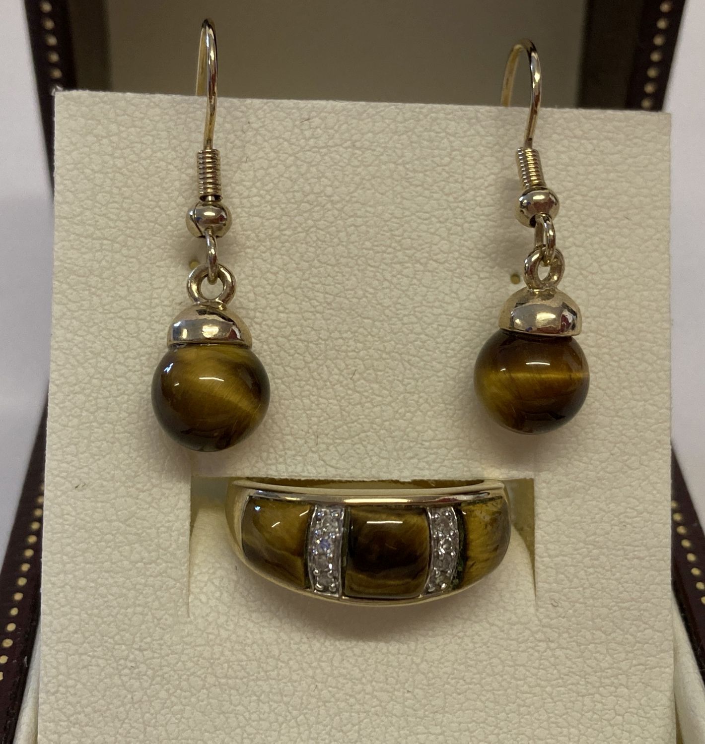 A 9ct gold tigers eye and diamond dress ring together with a pair of tigers eye drop earrings.