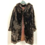 A vintage full length ladies dark fur coat with shawl collar and turned back cuffs.