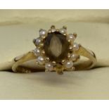 A 9ct gold dress ring set with smoked quartz and seed pearls.