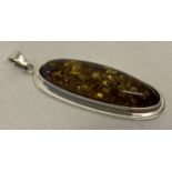 A long oval faux amber pendant set in a silver mount. Bale stamped 925.