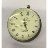 A glass ball watch, bound in brass with roman numeral markers.