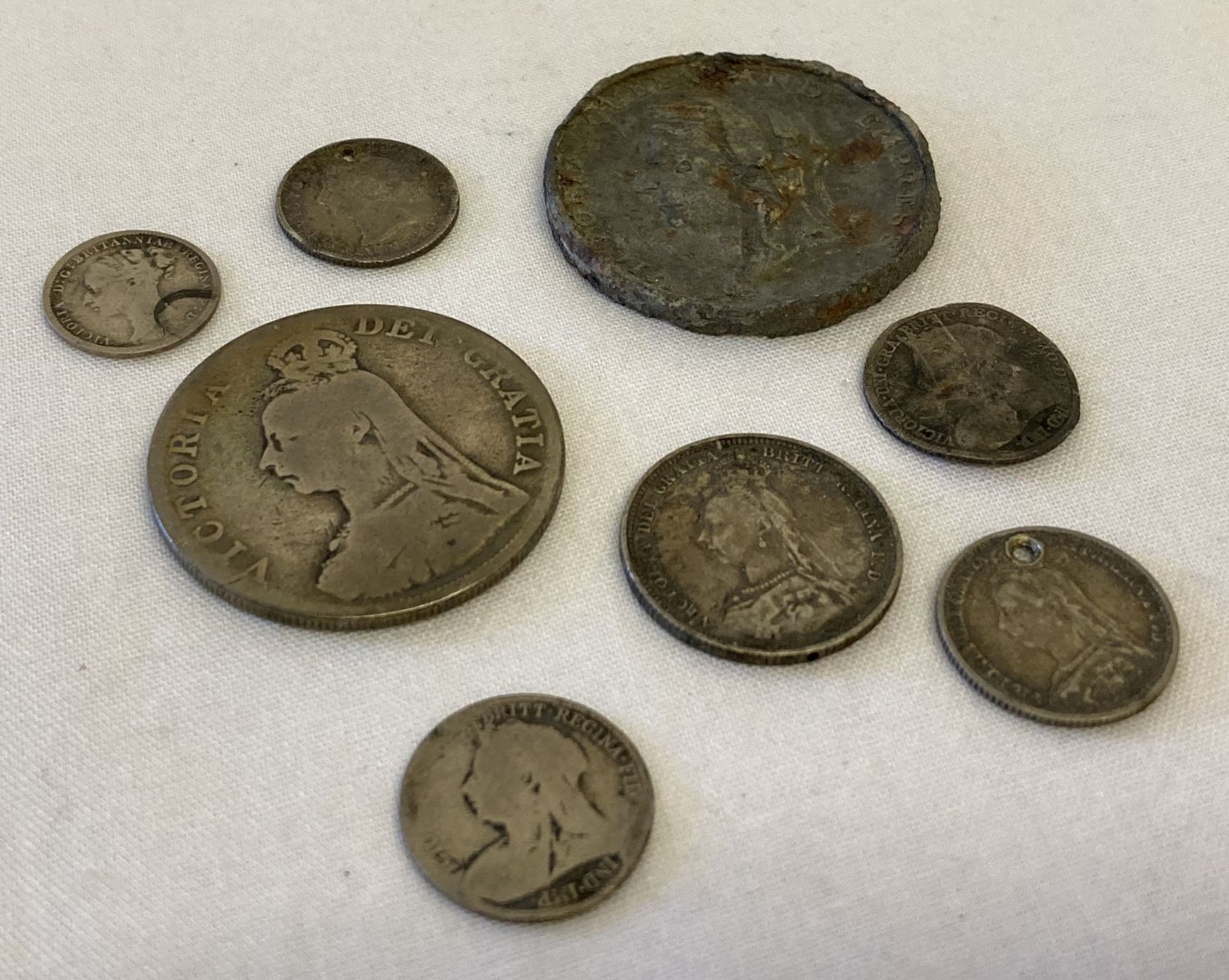 8 silver and white metal Victorian coins in varying conditions.