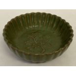 A celadon glaze stoneware shallow bowl with cherry blossom detail to inner bowl.