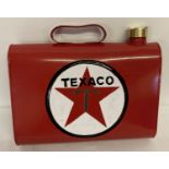 An oval shaped painted Texaco petrol can with brass screw on lid and mountable fixings on reverse.