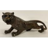 A hollow bronze figurine of a roaring tiger.