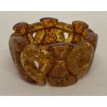 A vintage chunky faux amber elasticated bracelet with heart shaped beads.