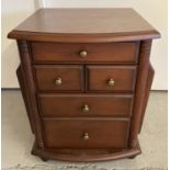 A dark wood modern 5 drawer side table with magazine racks to each side.