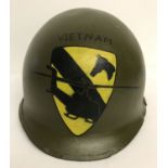 A Vietnam War era M1 helmet with post war hand painted memorial to the 1st Air Cavalry.