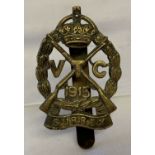A British WWI Surrey Volunteer Corps cap badge with slider fixing to reverse.