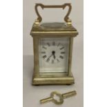 A small modern silver plated carriage clock with enamelled face and bevel edged glass panels.