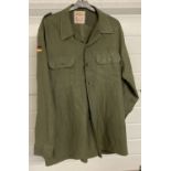 A 1988 Germany military khaki green shirt with German flag cloth badges. By jeans Express.