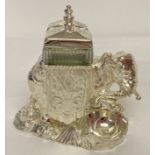 A modern silver plated cruet in the shape of an elephant, with cut glass bottles & engraved detail.