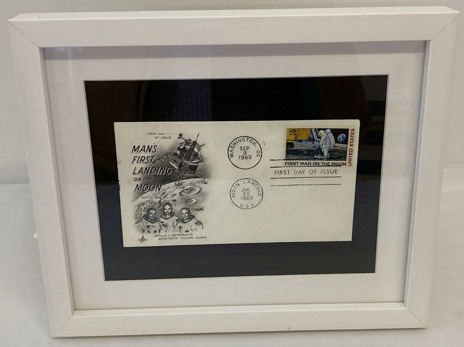 A framed and glazed American 1969 first day cover "Man's First Landing On The Moon".
