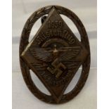 A German WWII style N.S.F.K. competition pin back badge.