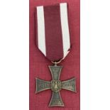 A modern copy of the Polish Cross Of Valour Medal on maroon and white ribbon.