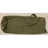 A khaki green canvas kit bag with canvas strap and lobster clasp fixing.