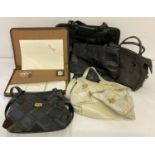 A collection of vintage leather and faux leather bags and leather zipped case writing set.