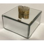 A modern mirrored jewellery box with druzy stone set as lid handle.