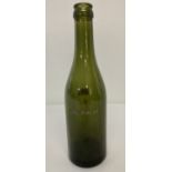 A WWII style German green glass beer bottle with engraved detail "For SS only".