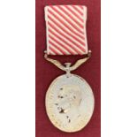 A modern copy of George VI The air Force Medal with red and white ribbon.