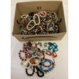 A box of costume jewellery necklaces, bracelets and earrings.