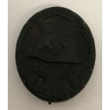 A WWII style German pin back black wound badge, 3rd class.