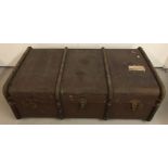 A vintage wooden and metal banded travelling trunk by Drawco, with leather carry handles.