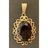 A 9ct gold pendant set with central smoked quartz.