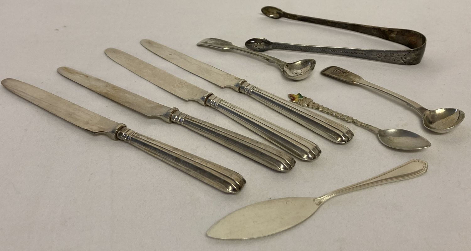 A small collection of vintage hallmarked cutlery items to include 4 silver handled butter knives.