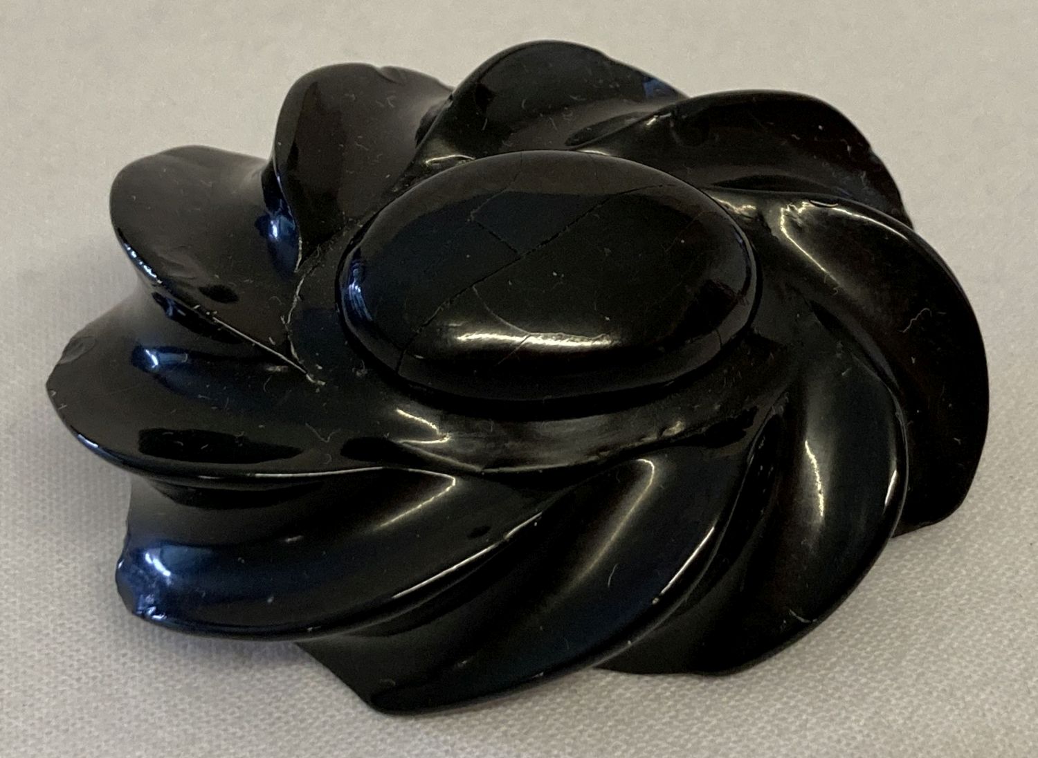 An Antique carved Whitby Jet brooch, approx 3.5cm x 5cm.